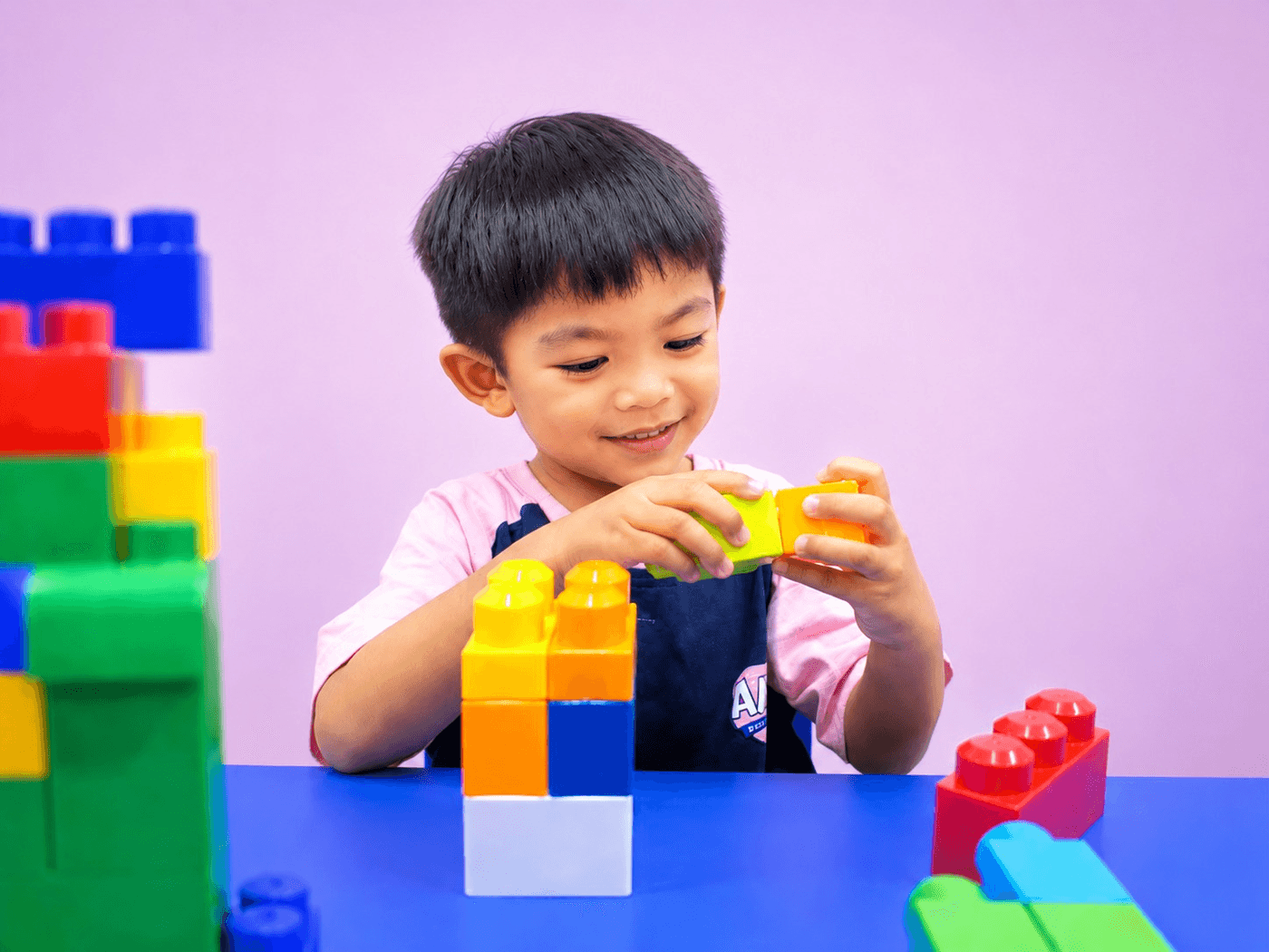 Toddler playing with building blocks at AMP Playschool