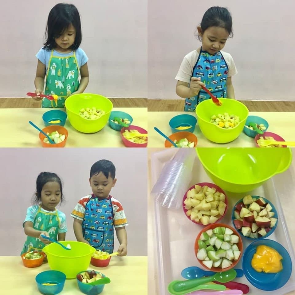 Children preparing a healthy fruit salad at AMP Preschool